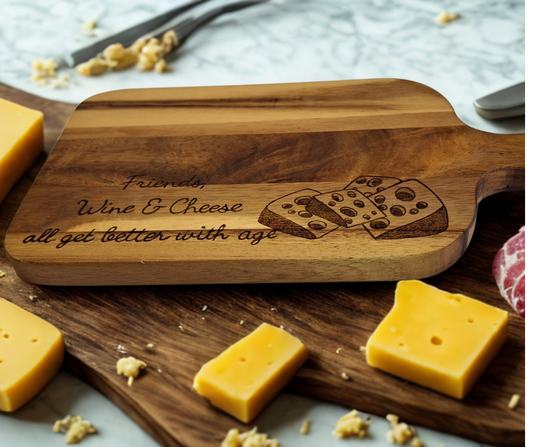 A multicolored, hand-decorated pyrography chopping board with the words "Friends, Wine & Cheese all get better with age" and illustrations of cheese chunks.
