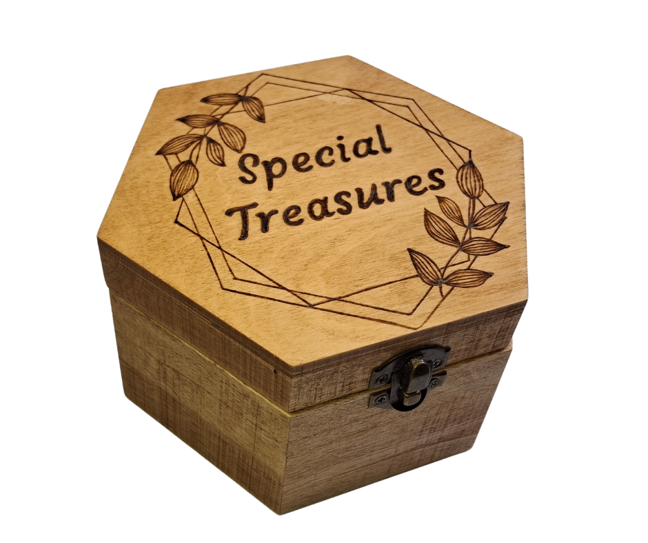 Box with "Special Treasures" inside a frame with leaves and straight lines burnt on top of the box