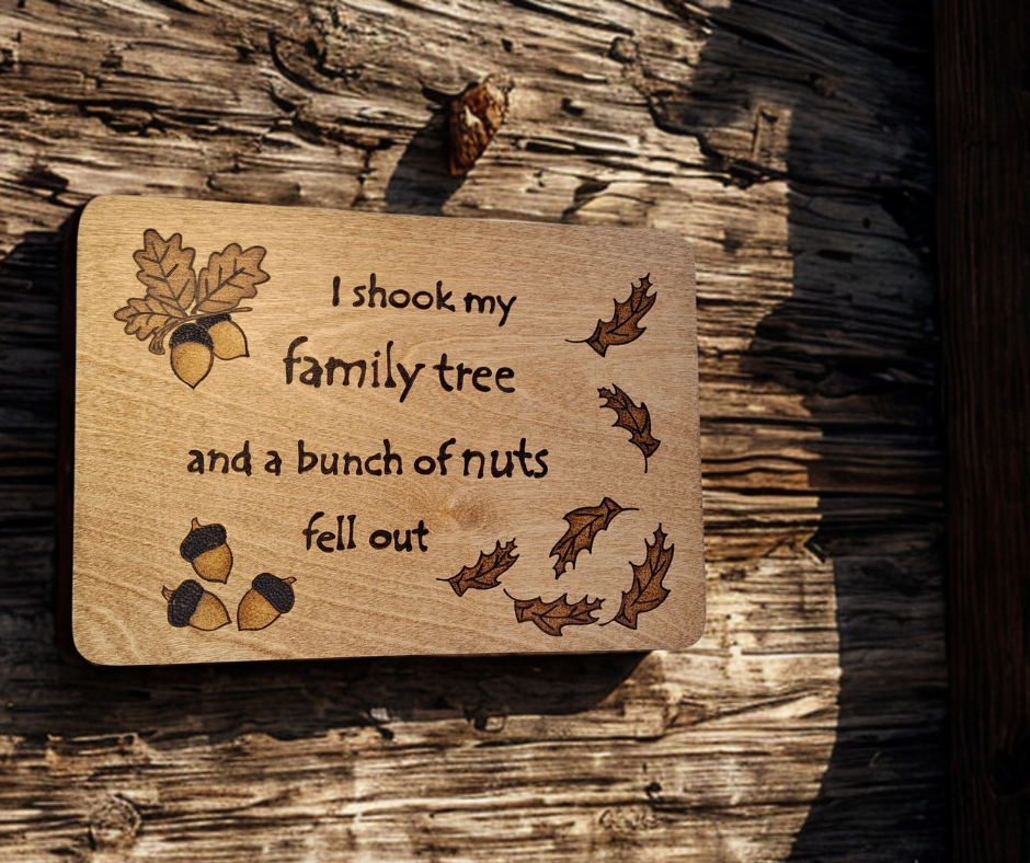 Wooden plaque hand-decorated with "I shook my family tree and a bunch of nuts fell out" pyrography and acorn illustrations
