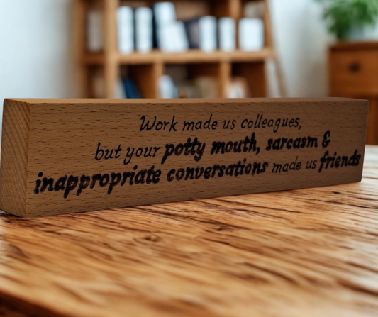 Freestanding wooden desk sign, hand-decorated with "Work made us colleagues but your potty mouth and sarcasm made us friends" pyrography.