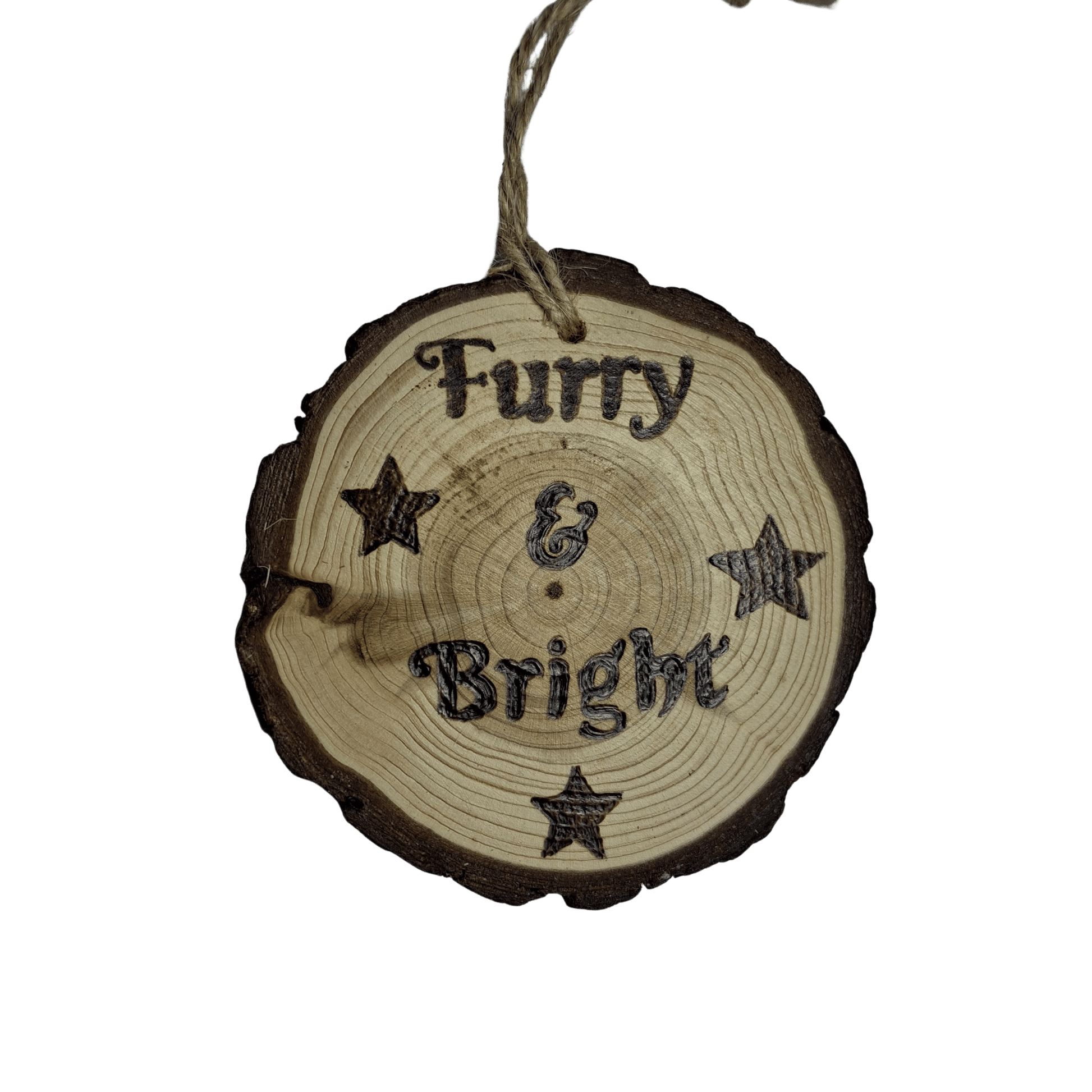 
A close-up of a Christmas ornament on a black background. The ornament is a round wooden log slice with a jute rope for hanging. The front of the log slice is decorated with a pyrography design featuring the text "Furry & Bright" surrounded by four stars.