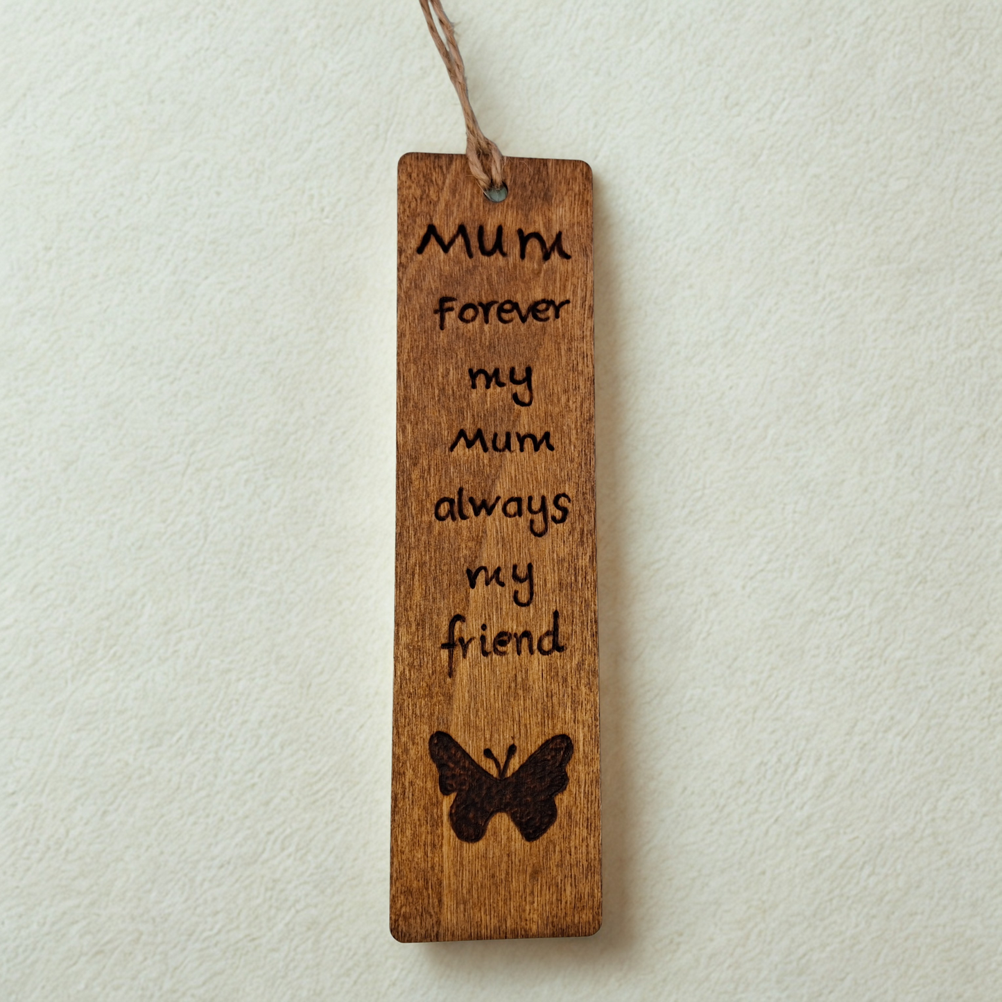 Dark wood bookmark with "Forever my Mum always my friendI love you" pyrography and a butterly illustration.
