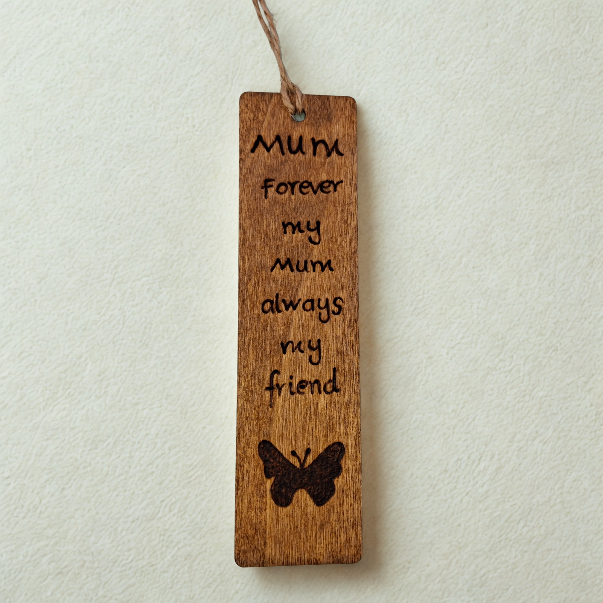 Dark wood bookmark with "Forever my Mum always my friendI love you" pyrography and a butterly illustration.