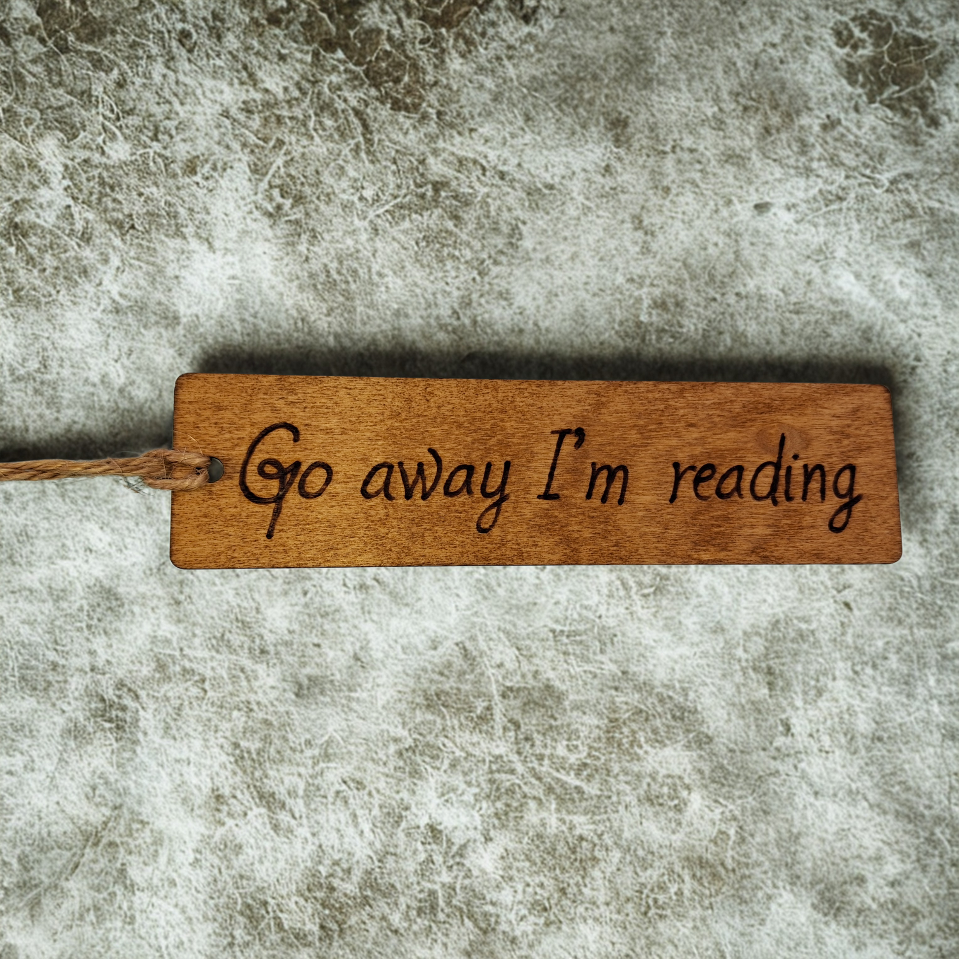 Dark wood bookmark with "Go away I'm reading" pyrography.
