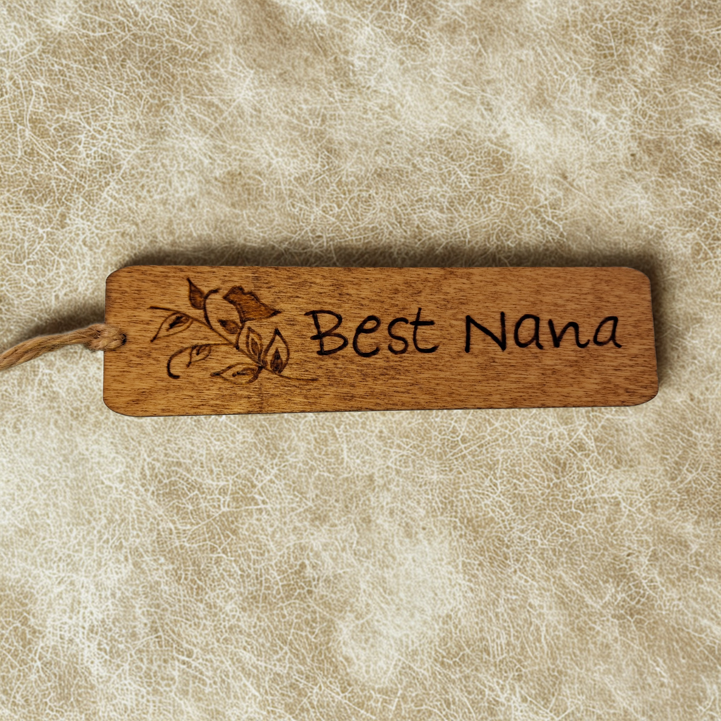 Dark wood bookmark with "Best Nana" pyrography and a bird on a branch illustration.