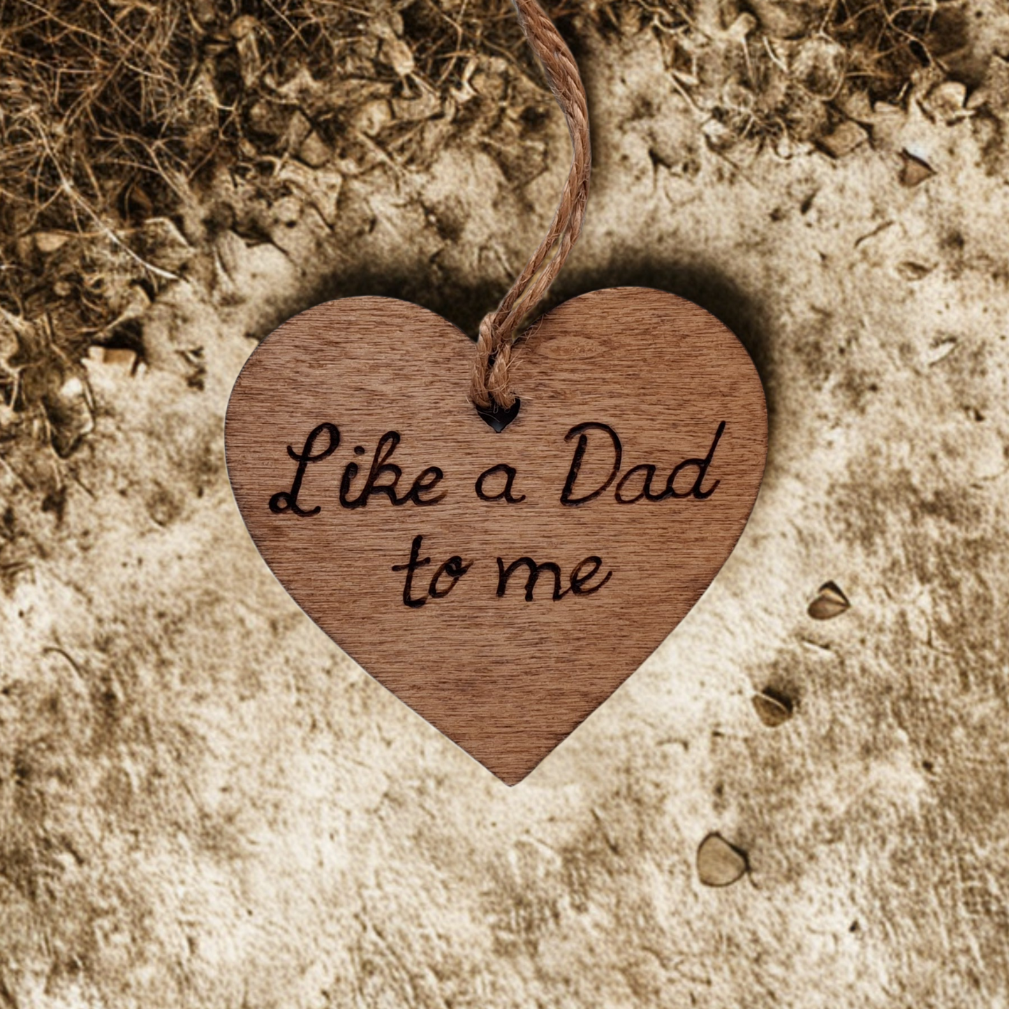 Wooden heart-shaped ornament with 'Like a Dad to me' engraved text and natural jute string for hanging