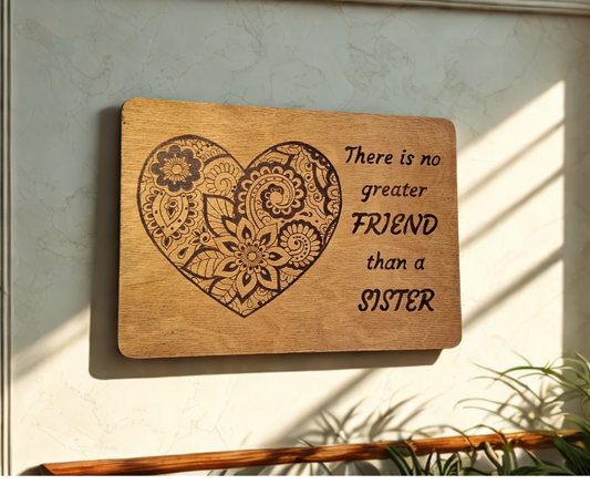 Hand-burnt wooden sign featuring the quote "No greater friend than a sister" and an intricately detailed mandala design within a heart