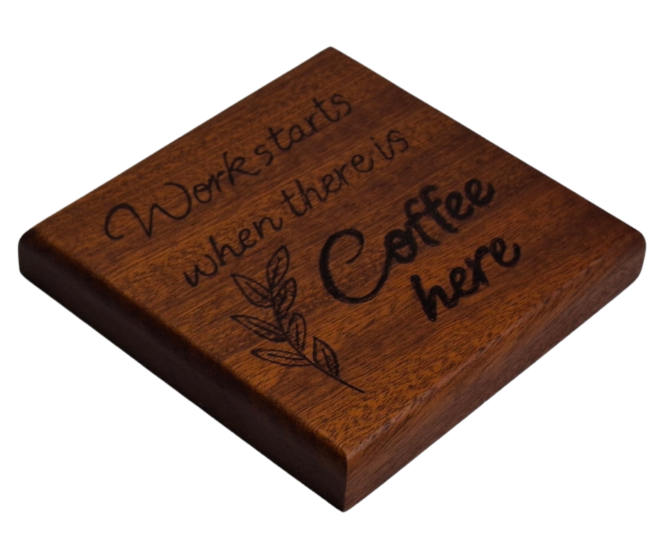 Sapele coaster with chamfered edges inscription "Work starts when there is coffee here" burnt in