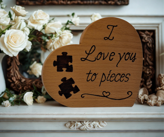 Freestanding heart-shaped wooden plaque, hand-decorated with "I Love You to Pieces" pyrography and two separated jigsaw pieces.