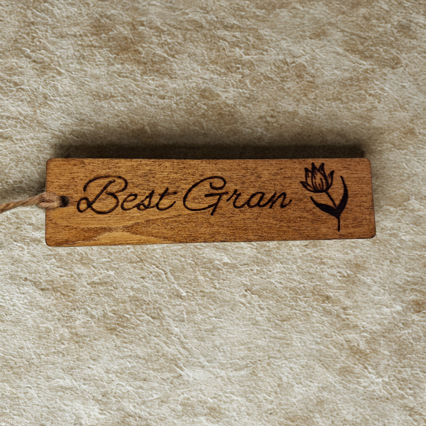 Dark wood bookmark with "Best Gran" pyrography and a flower illustration.