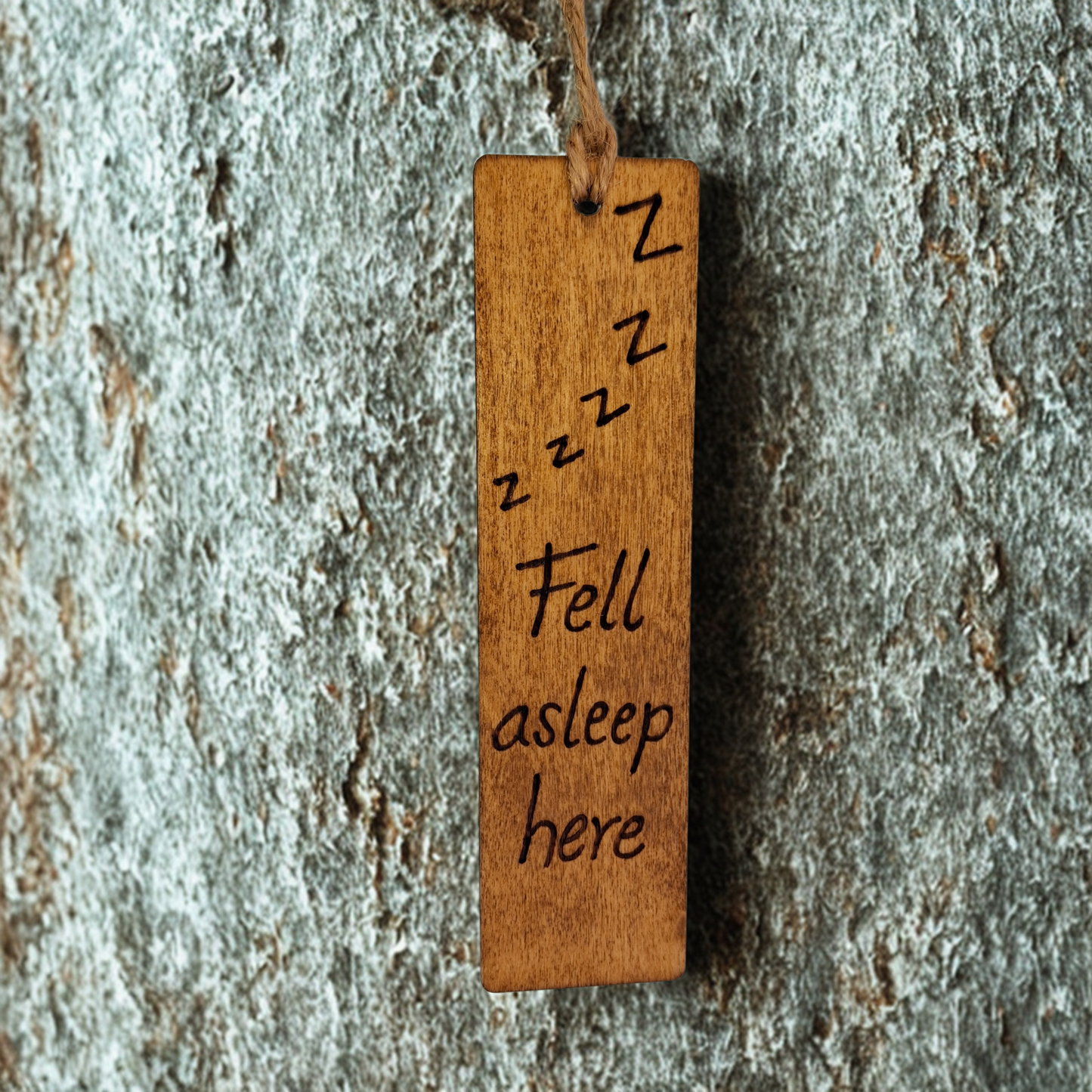 Dark wood bookmark with "Fell asleep here" pyrography and a line of 'Z's illustration.
