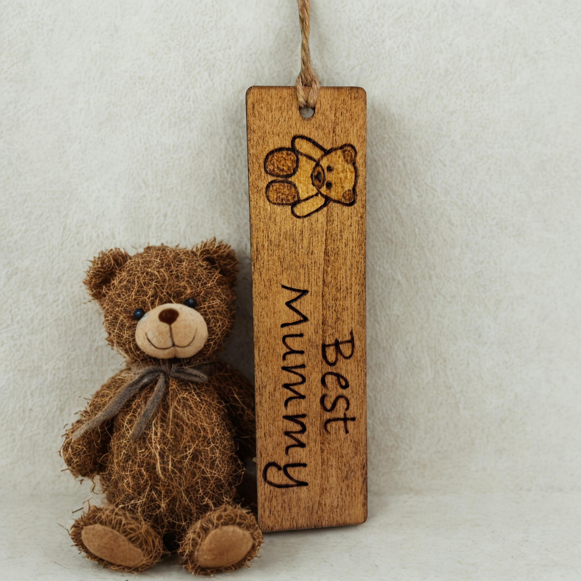 Dark wood bookmark with "Best Mummy" pyrography and a teddy bear illustration.