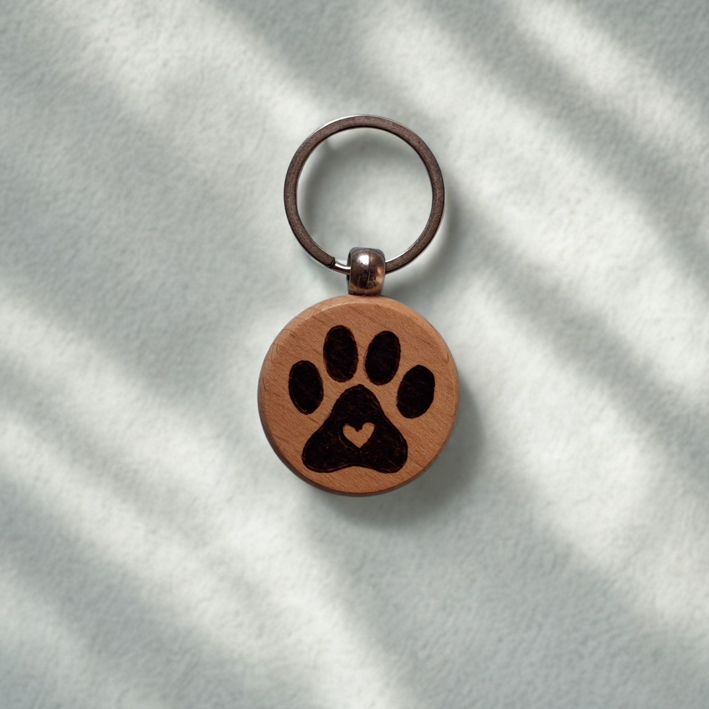 Round beechwood keyring with paw print and heart pyrography design and chrome split ring