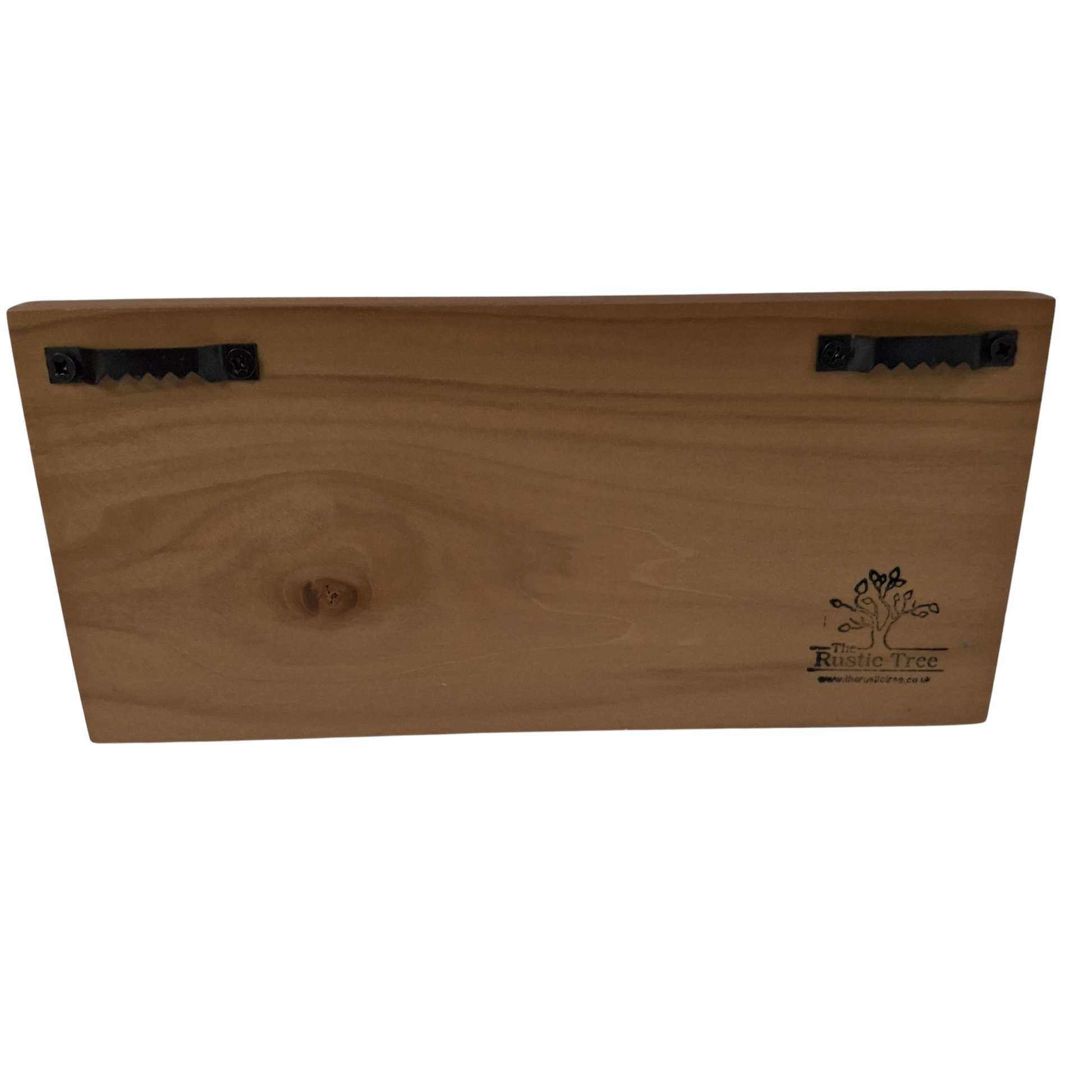 Rear of wooden plaque showing 2 sawhooks and The Rustic Tree logo