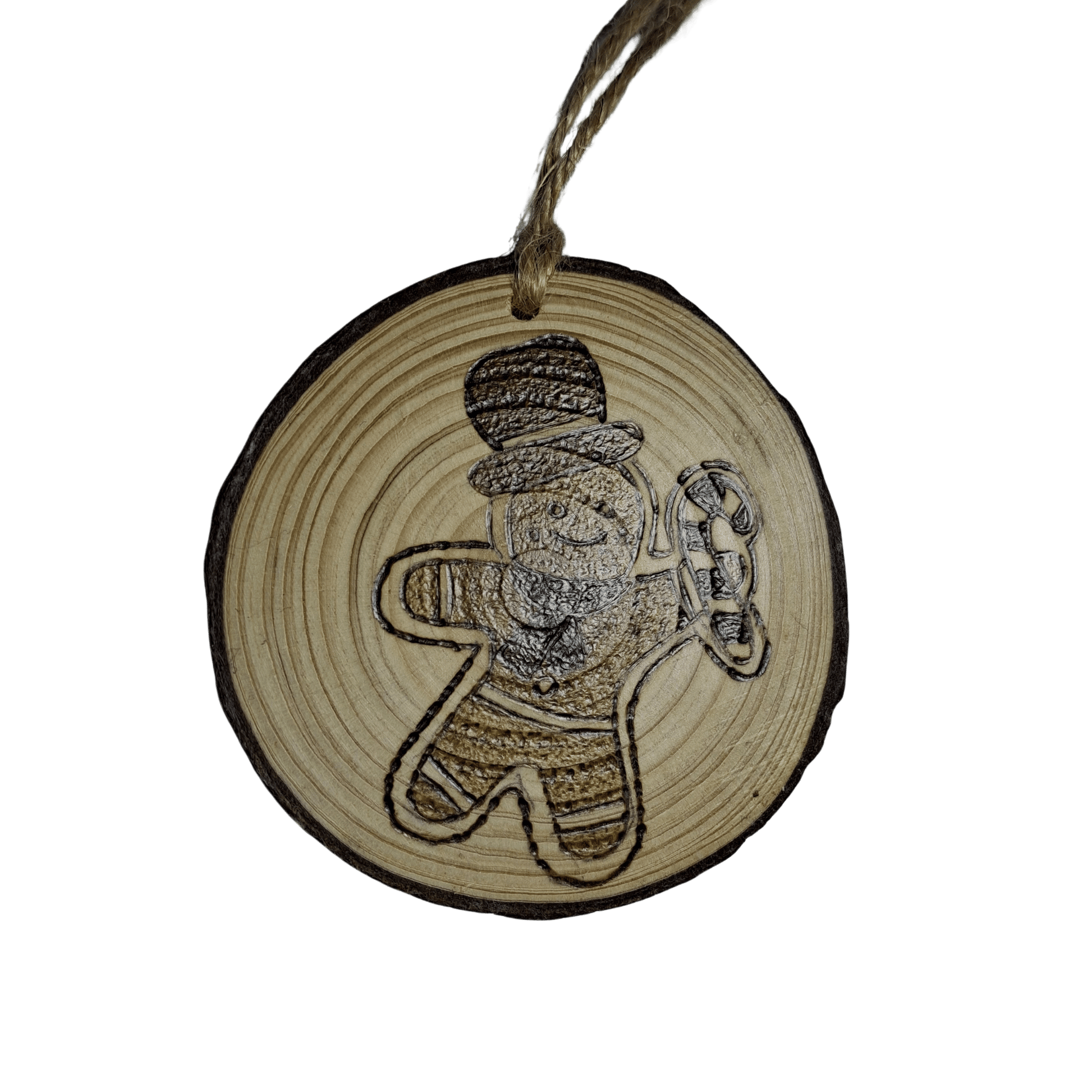 
A small, round Christmas ornament on a black background. The ornament is made from a wooden log slice and has a jute rope for hanging. The front of the ornament is decorated with a pyrography design of a gingerbread man wearing a top hat and holding a candy cane.