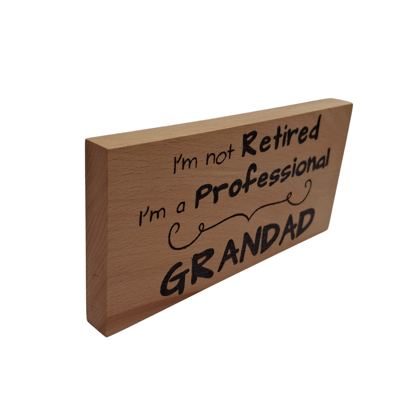 Wooden sign with text 'I'm not retired, I'm a professional grandad' hand burnt 
