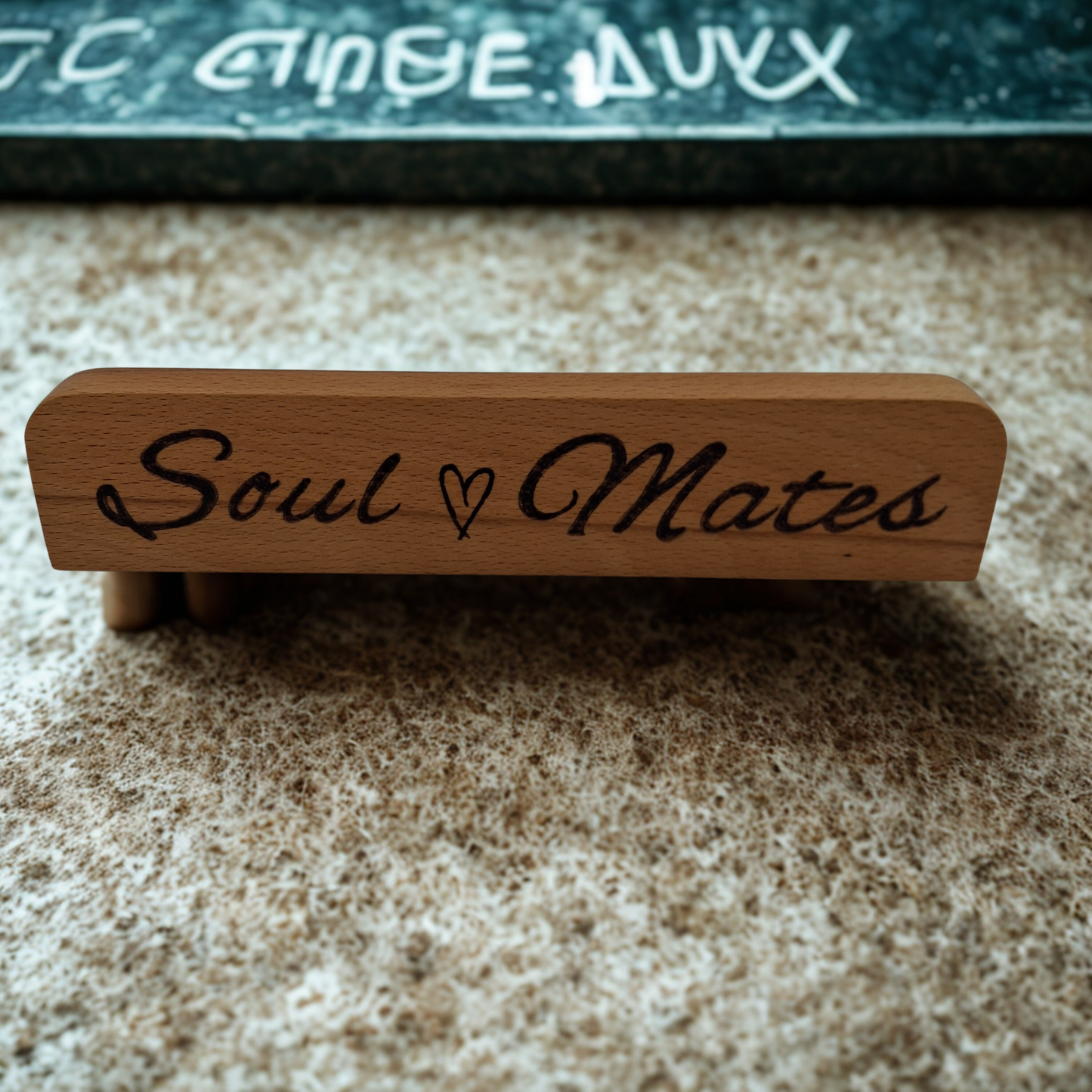 Wooden block with 'Soul Mates' hand burnt on a textured surface