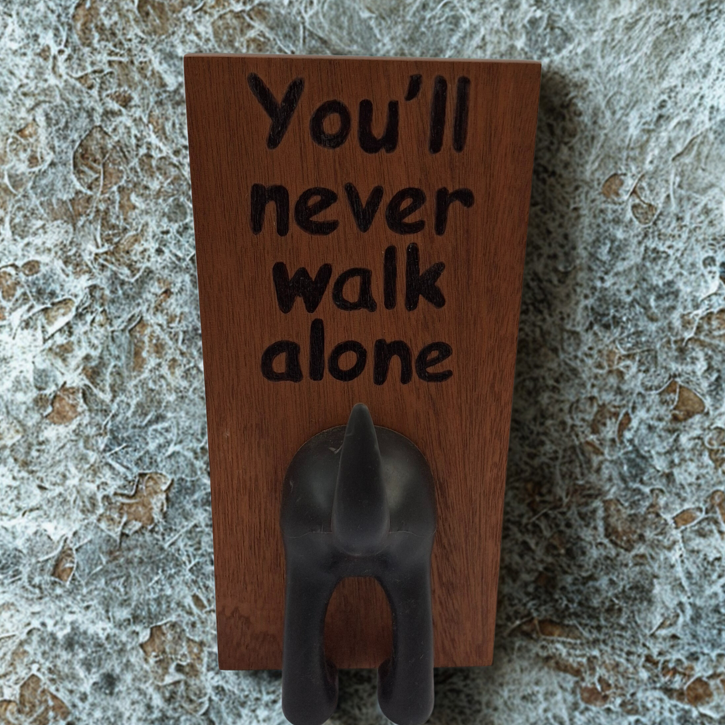 Dark wooden plaque with a rubber dog tail for hanging leads, You'll never walk alone hand burnt into the wood