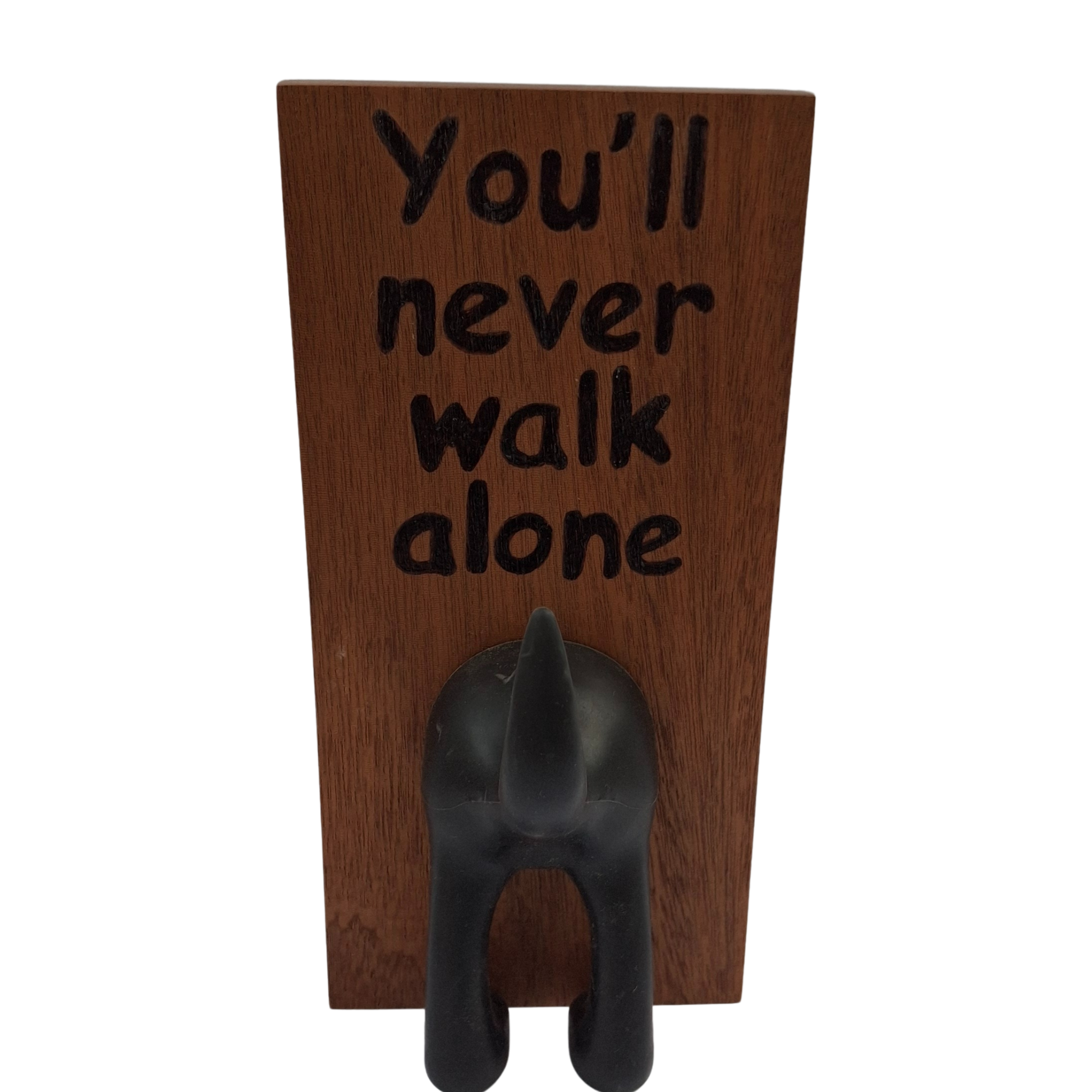 Wooden plaque with 'You'll never walk alone' text and a dog-shaped hook on a white background