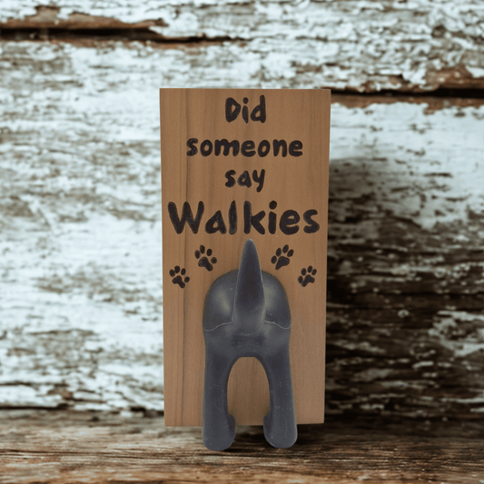 Wooden wall hook featuring the excited phrase "Did someone say Walkies" created with pyrography (hand burnt lettering and paw prints). A black dog's hindquarters and tail are attached to the bottom to form the hook.