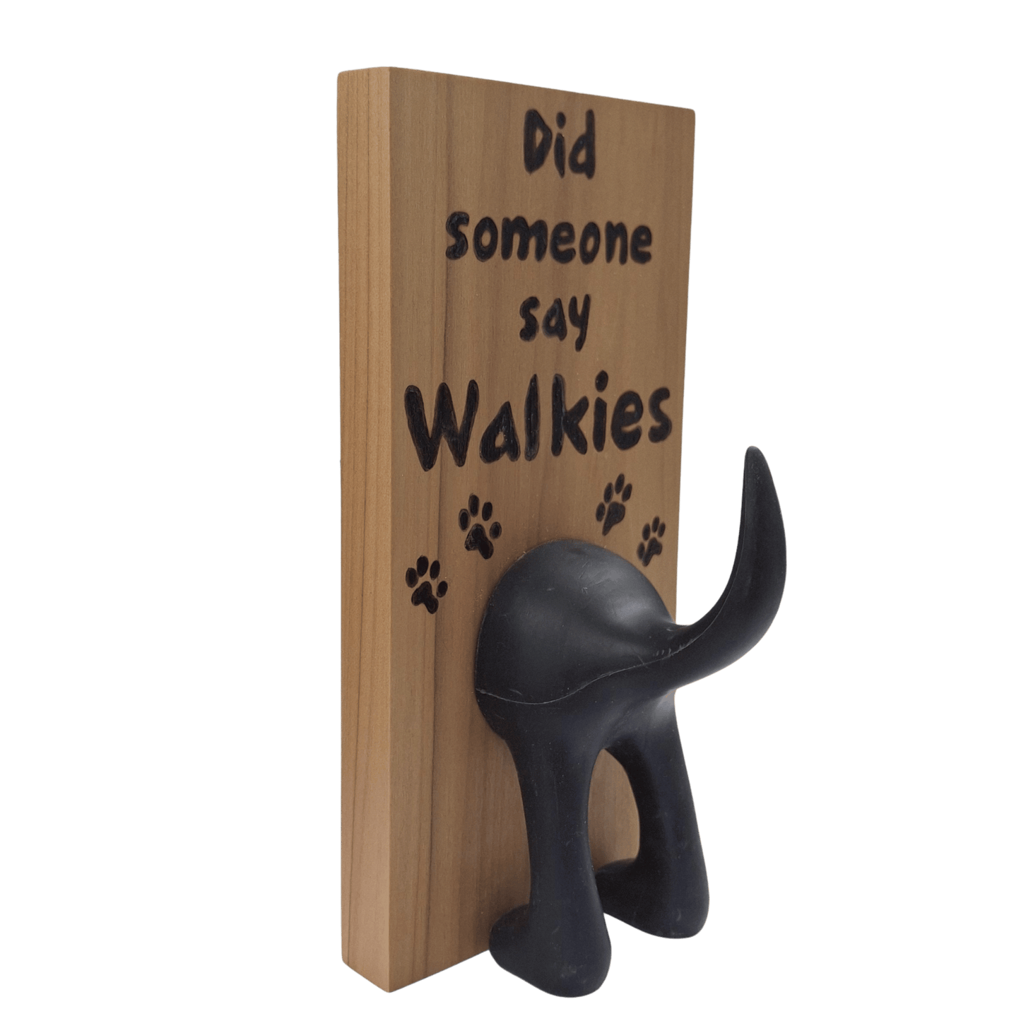 Wooden wall hook featuring the excited phrase "Did someone say Walkies" created with pyrography (hand burnt lettering and paw prints). A black dog's hindquarters and tail are attached to the bottom to form the hook.