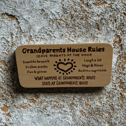 Light wooden plaque with a list of "Grandparents house rules" and an image of a heart hand burnt into the wood