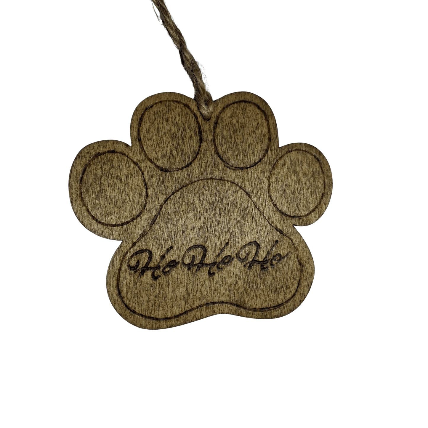 
A wooden Christmas ornament shaped like a dog's paw print. The wood is light brown with visible grain patterns. A twisted twine loop is threaded through a hole at the top for hanging. The words "Ho Ho Ho" are carved into the center of the paw. The background is solid black.