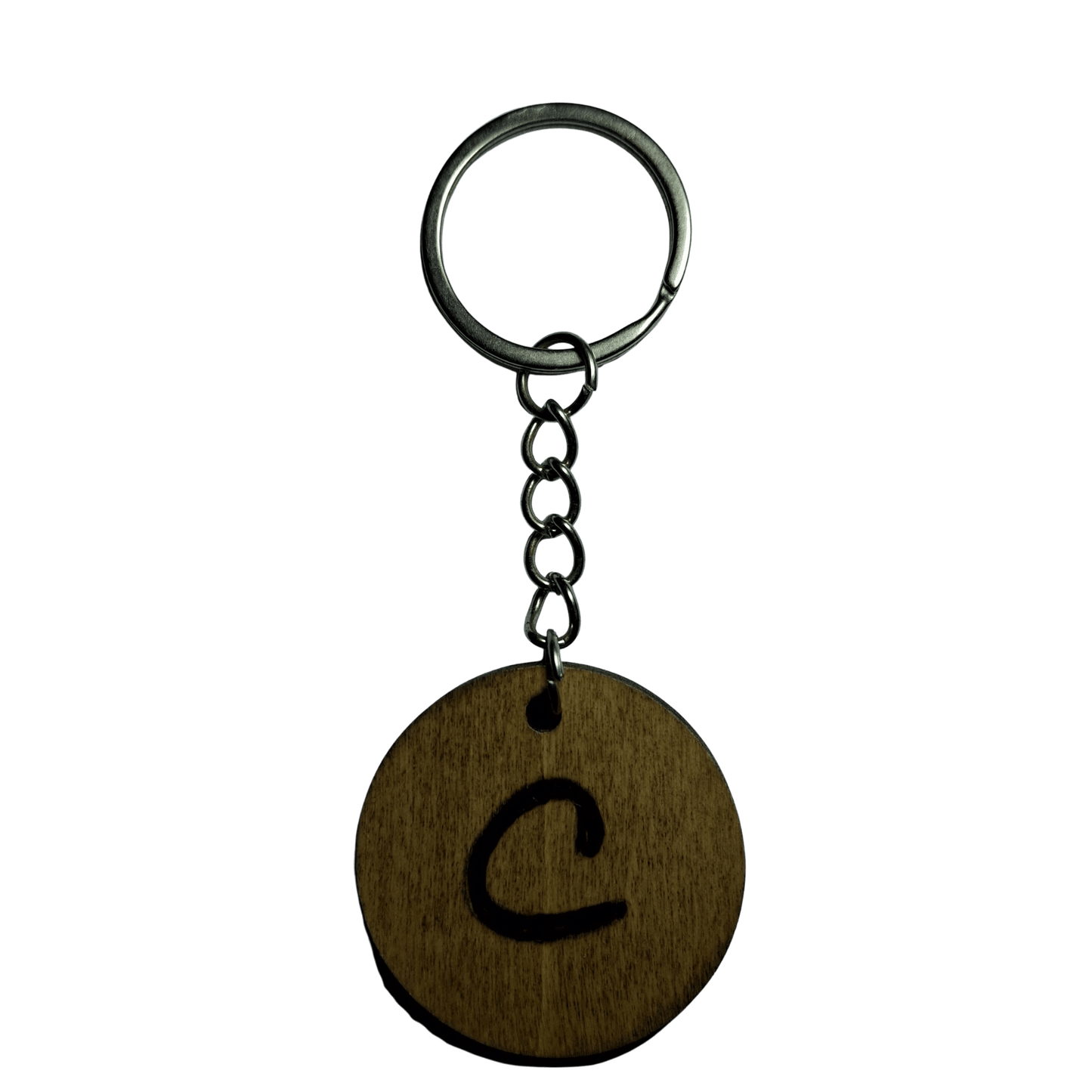 Round keyring made from veneered plywood. The letter C is hand-burnt using pyrography, finished with a hardwax oil, and attached to a silver keychain.