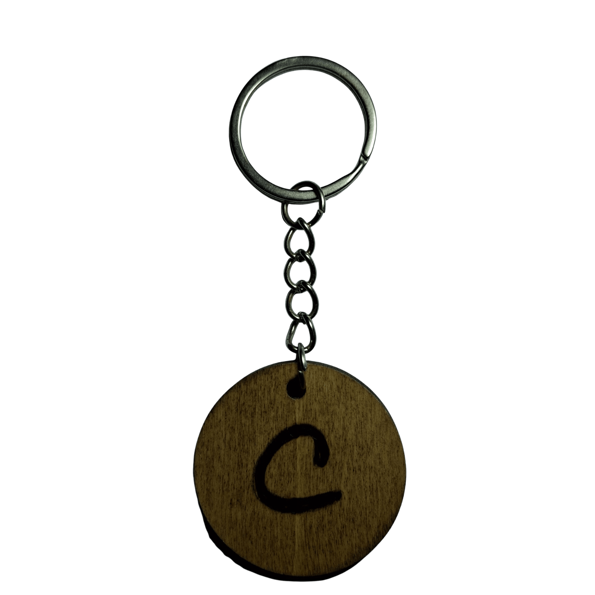 Round keyring made from veneered plywood. The letter C is hand-burnt using pyrography, finished with a hardwax oil, and attached to a silver keychain.