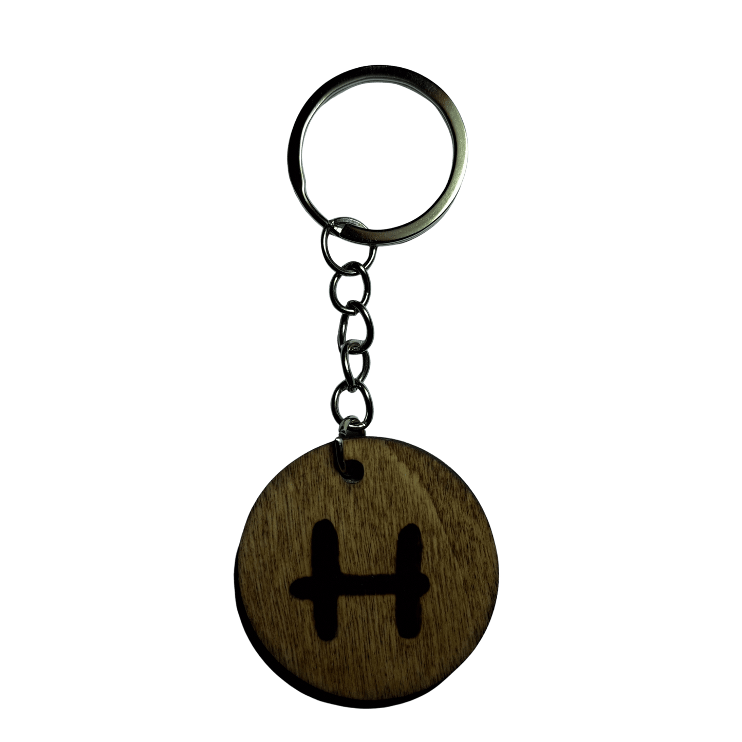 Round keyring made from veneered plywood. The letter H is hand-burnt using pyrography, finished with a hardwax oil, and attached to a silver keychain.