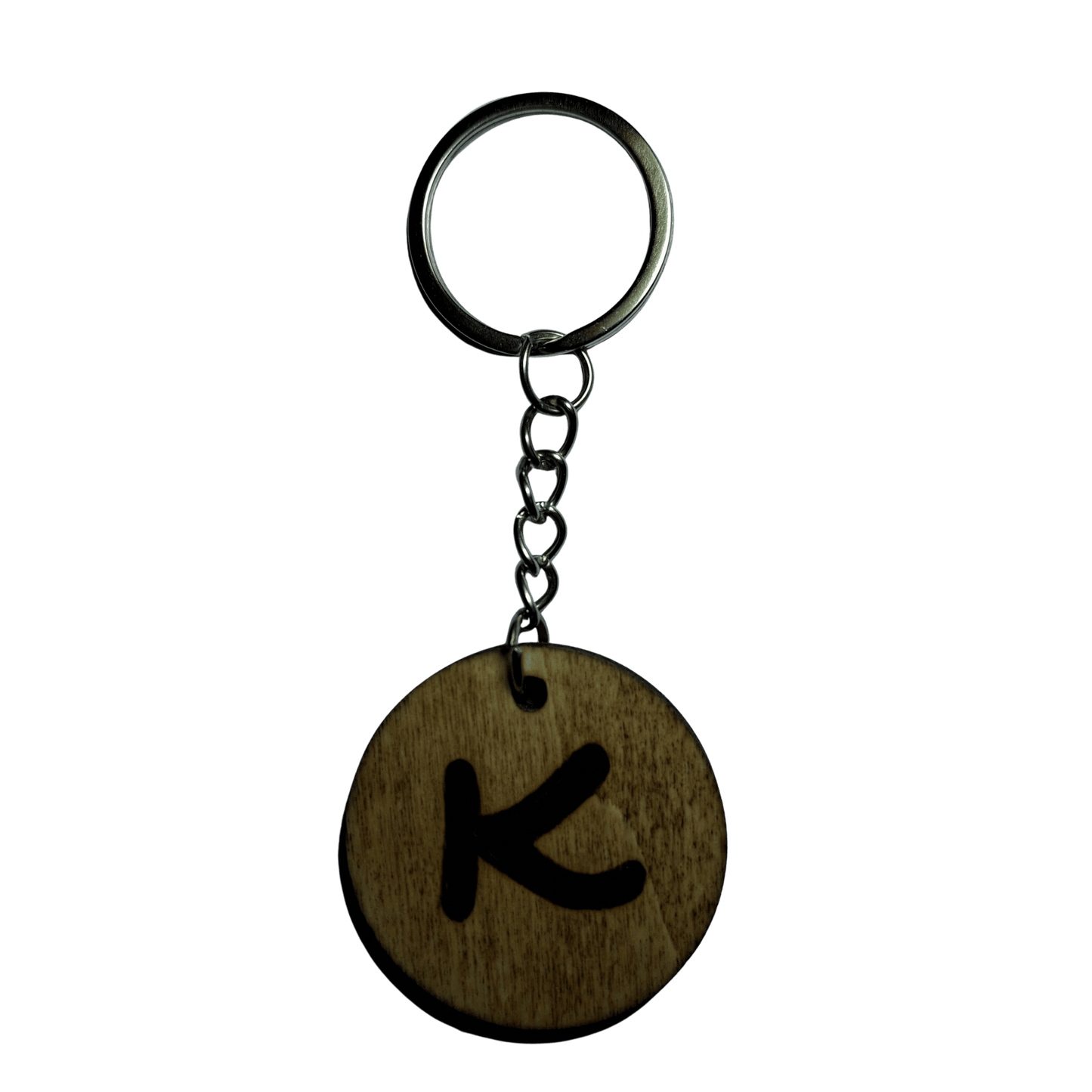 Round keyring made from veneered plywood. The letter K is hand-burnt using pyrography, finished with a hardwax oil, and attached to a silver keychain.