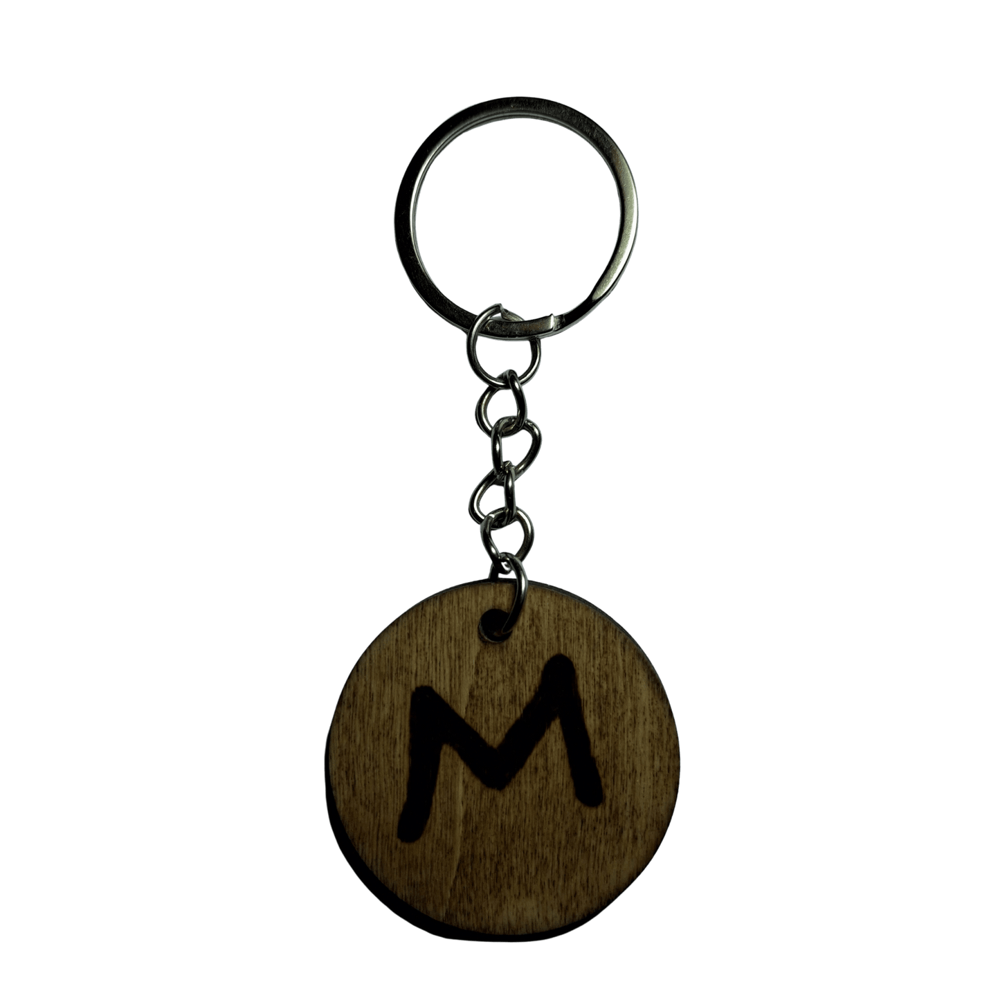 Round keyring made from veneered plywood. The letter M is hand-burnt using pyrography, finished with a hardwax oil, and attached to a silver keychain.