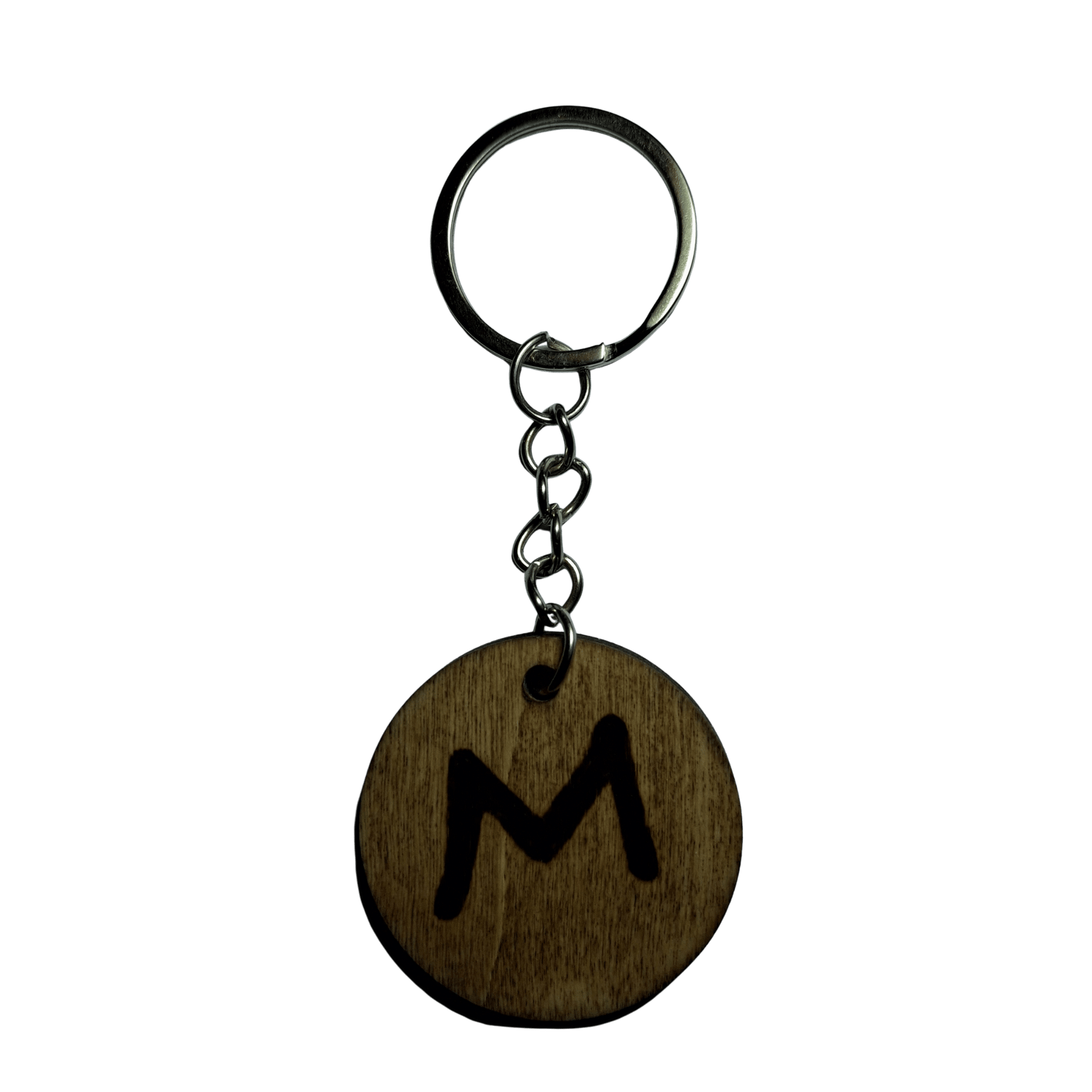 Round keyring made from veneered plywood. The letter M is hand-burnt using pyrography, finished with a hardwax oil, and attached to a silver keychain.