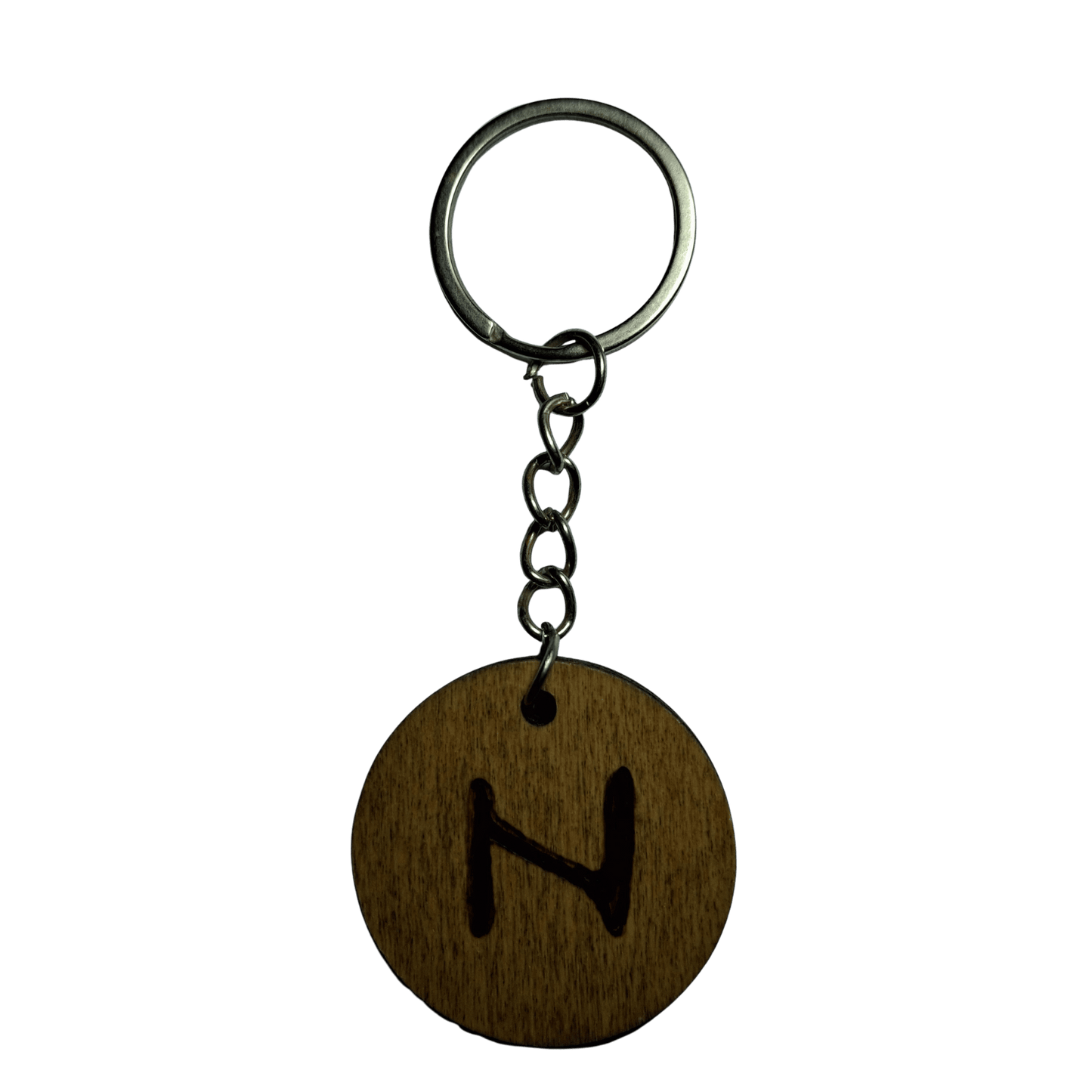 Round keyring made from veneered plywood. The letter N is hand-burnt using pyrography, finished with a hardwax oil, and attached to a silver keychain.