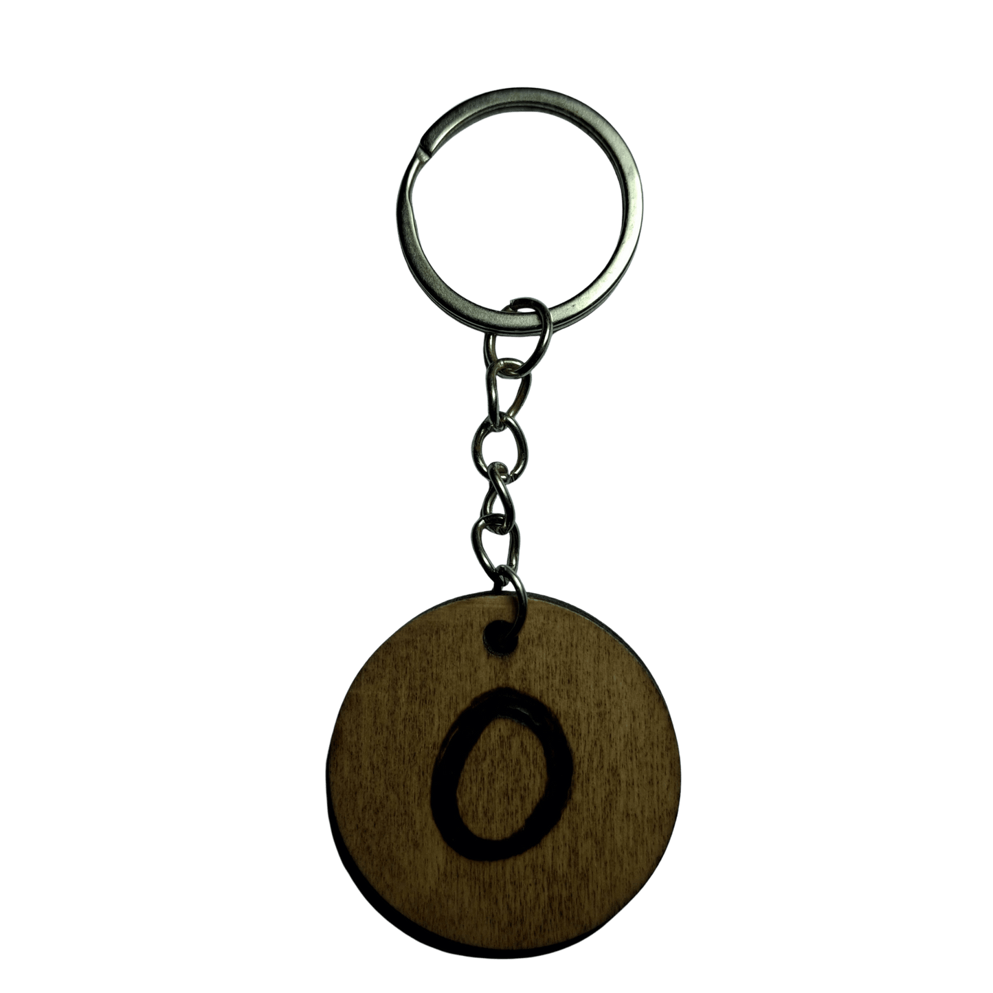 Round keyring made from veneered plywood. The letter O is hand-burnt using pyrography, finished with a hardwax oil, and attached to a silver keychain.