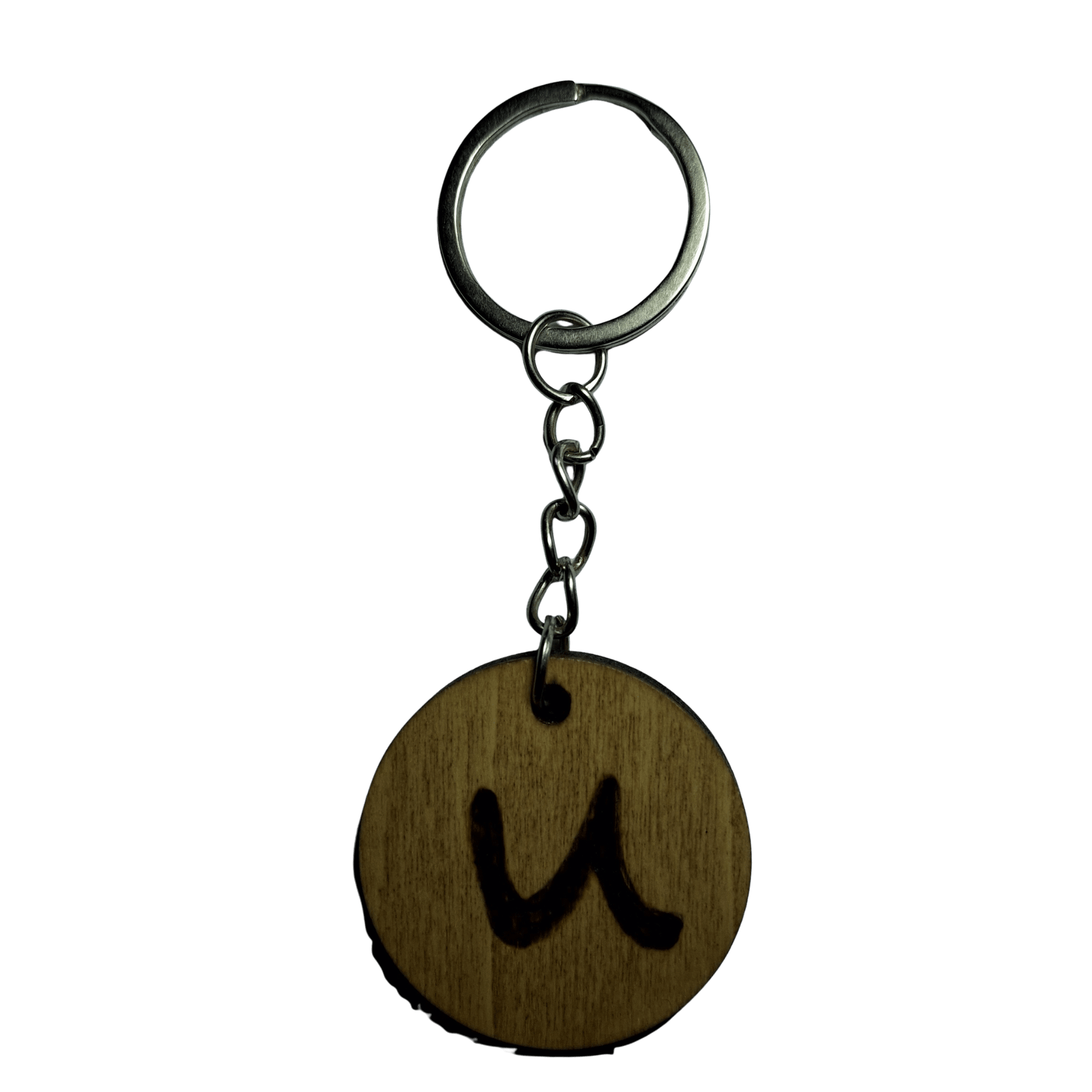 Round keyring made from veneered plywood. The letter U is hand-burnt using pyrography, finished with a hardwax oil, and attached to a silver keychain.