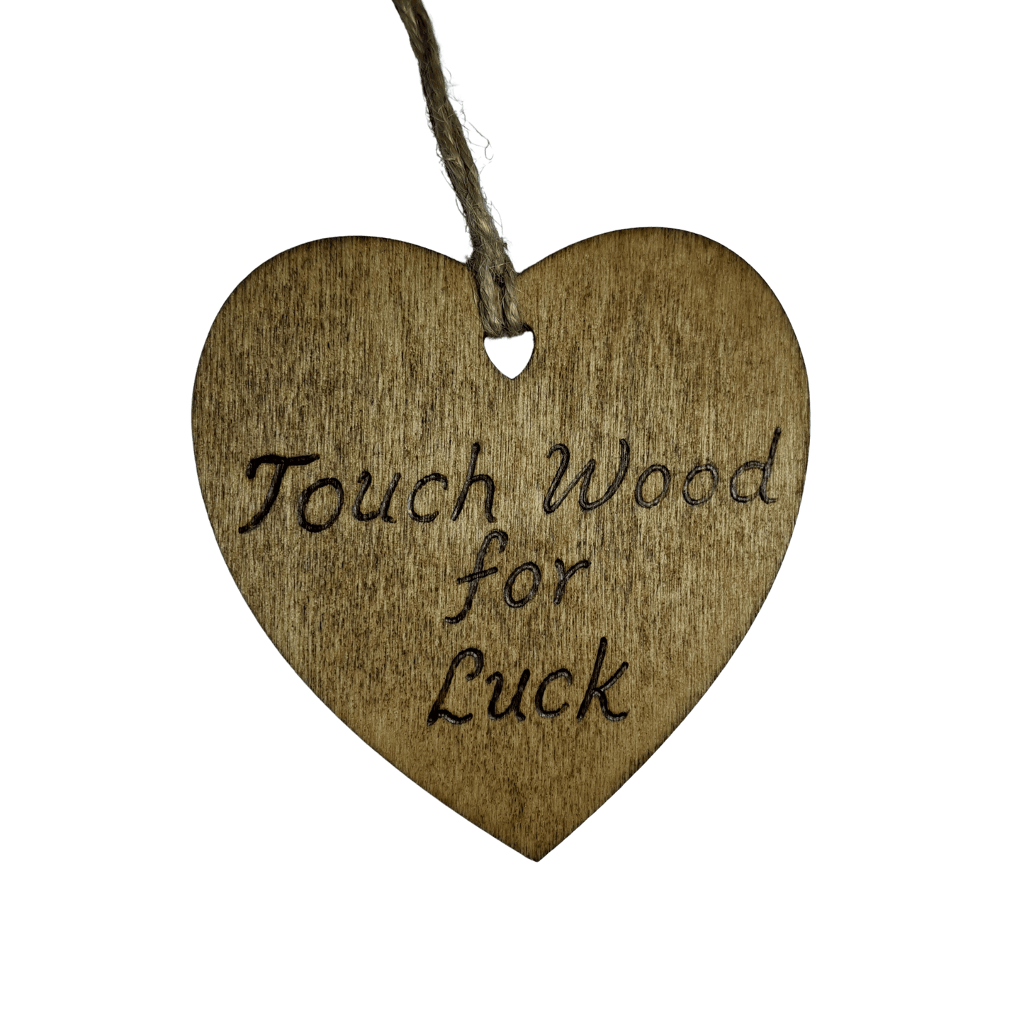 
A brown, wooden, heart-shaped plaque with a hole at the top for a string to hang it. The string is made of twisted twine. The words "Touch Wood for Luck" are burned into the surface in a handwritten font. The heart is lit from the front, making the wood grain visible. The background is solid black.