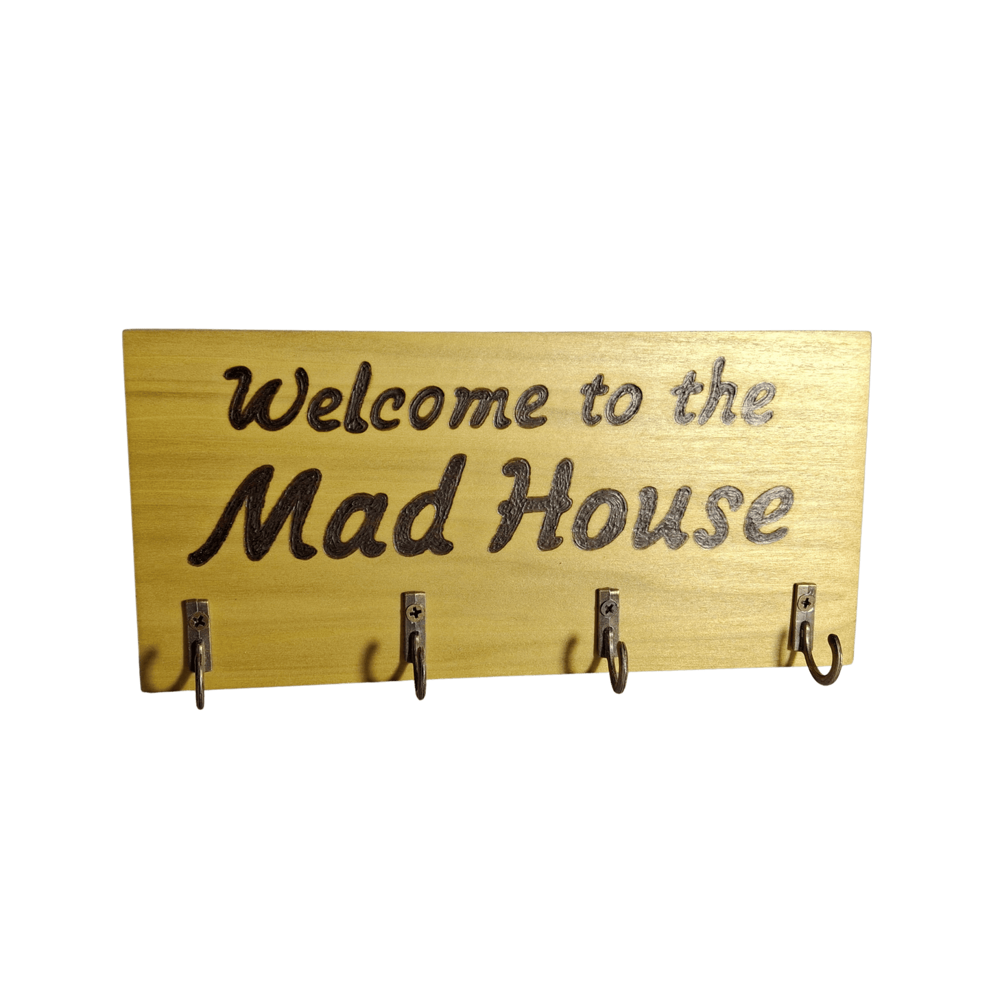 Wooden plaque with 'Welcome to the Mad House' text and four hooks on a green background