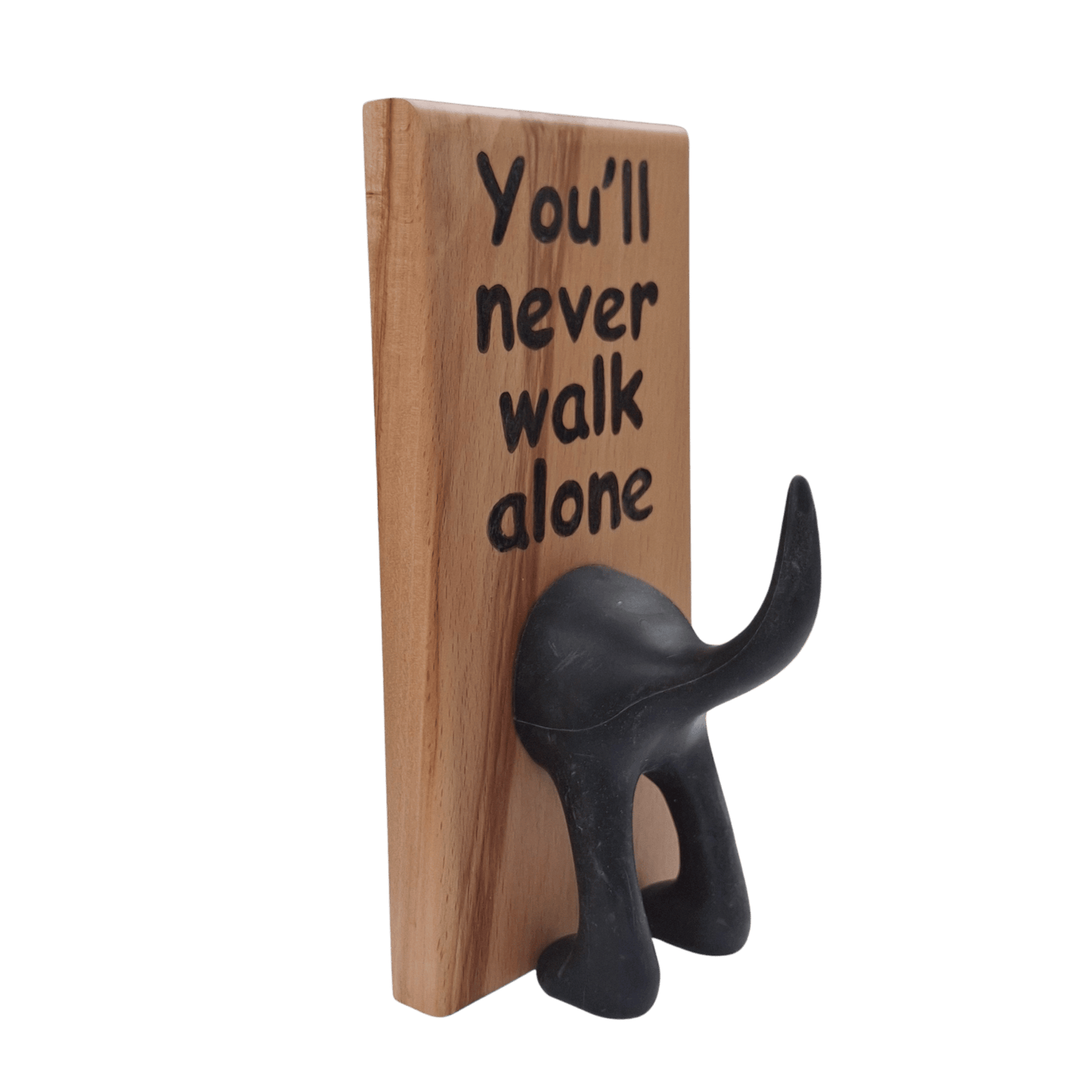 Wooden wall hook featuring the phrase "You'll never walk alone" created with pyrography (hand burnt lettering). A black dog's rear end forms the hook. 